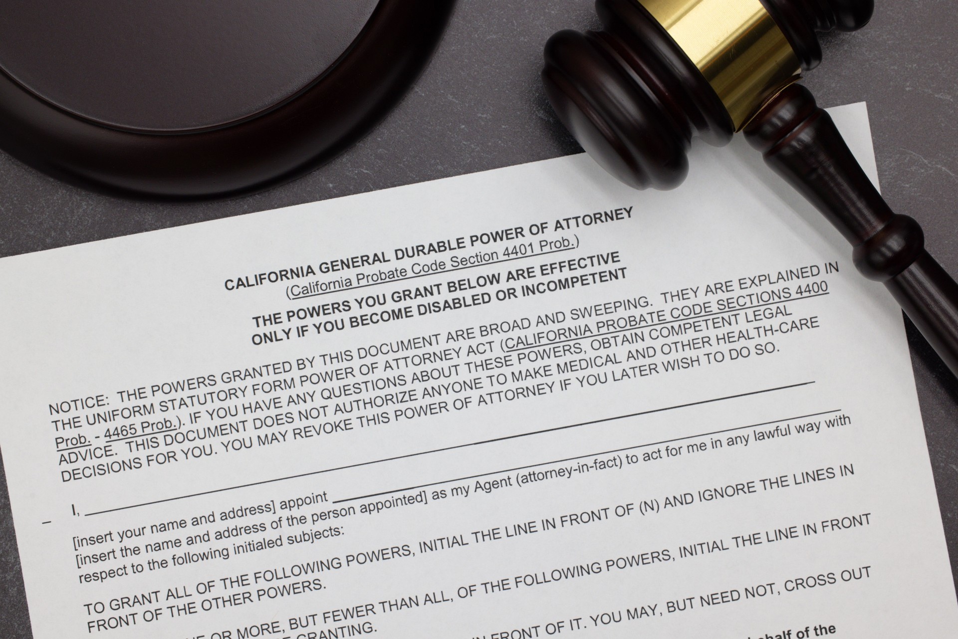 California General Durable Power of Attorney legal form with gavel and block on slate desktop